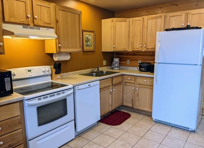 Kitchen with a refrigerator, stove, and dishwasher.
