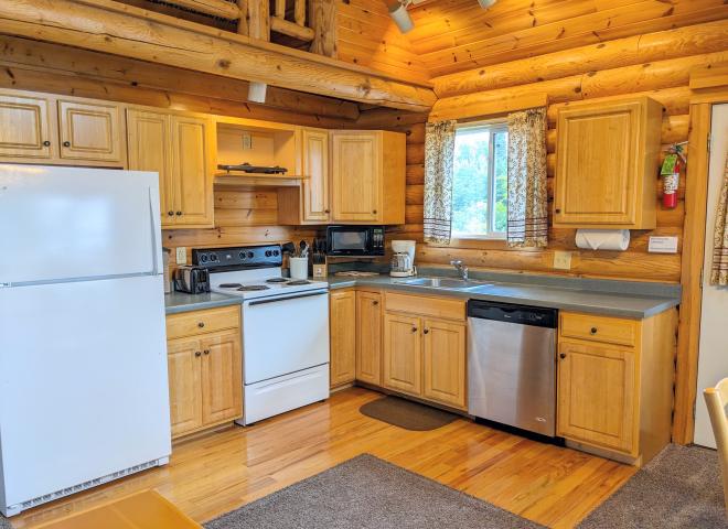 Kitchen with a refrigerator, stove, and dishwasher.