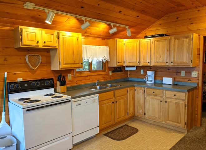 Kitchen with a refrigerator, stove, and dishwasher.