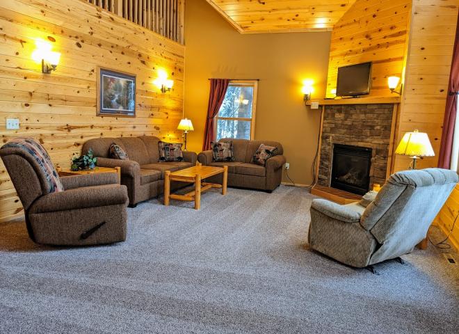 Living room with couch, loveseat, recliner, and gas fireplace.