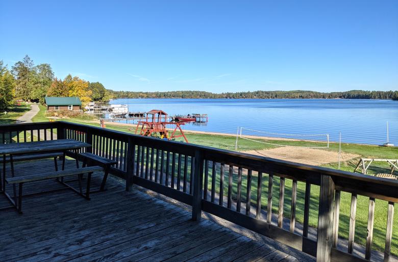Deck overlooking the beach, with picnic table and charcoal grill.