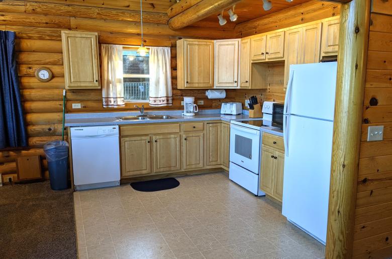 Kitchen with a refrigerator, stove, and dishwasher.