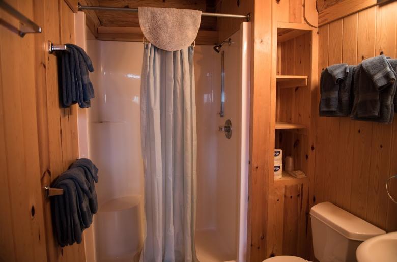 Main floor bathroom with a wide door and easy access shower and sink.