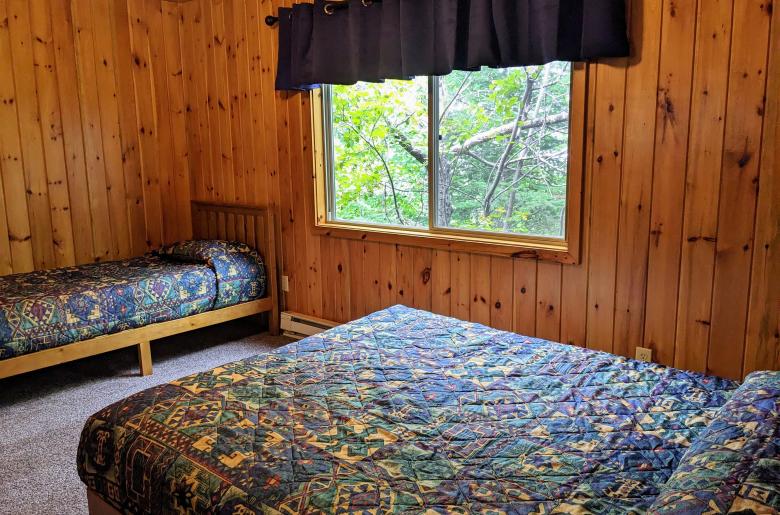 Upstairs bedroom with a queen and twin bed.
