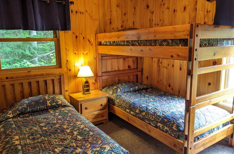 Upstairs bedroom with a twin and set of twin bunk beds.