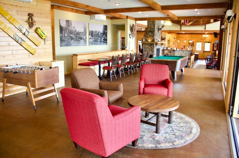 Pool table, foosball, and seating area in the main lodge.
