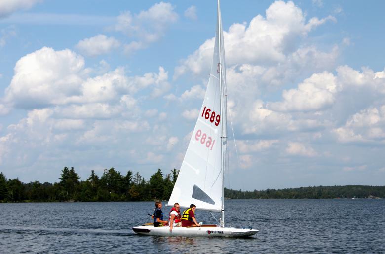 Group of three young boys sailing on MC Scow