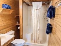 Main floor bathroom with a wide door and easy access shower and sink.